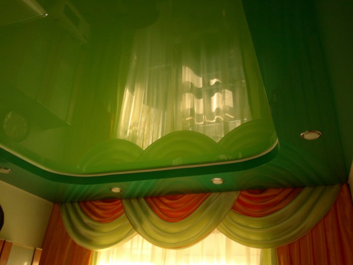 Оригинальные натяжные потолки для гостиной. В один уровень светло зеленый потолок смотрелся бы уныло и не закончено.